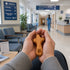 Hand holding a comfort cross in a hospital waiting room