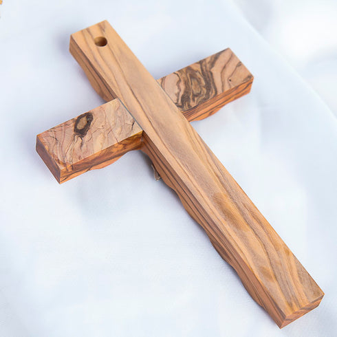 Back of an olive wood cross on white background
