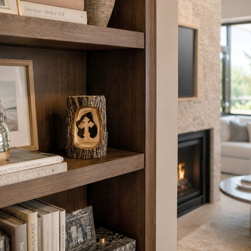 Wooden bookshelf with decorative items in a living room setting