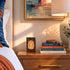 Nighstand with books and decorative items in a bedroom setting