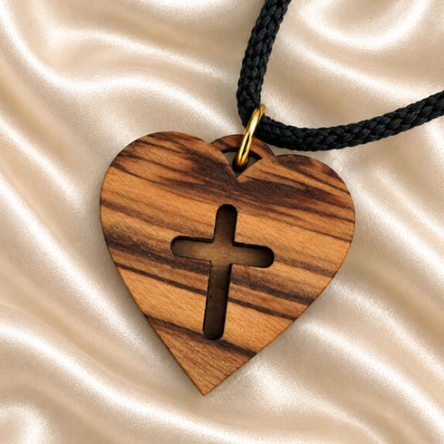 Olive wood heart pendant with cross and black cord, close-up
