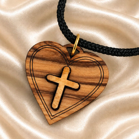 Wooden heart cross pendant with gold cap on black cord