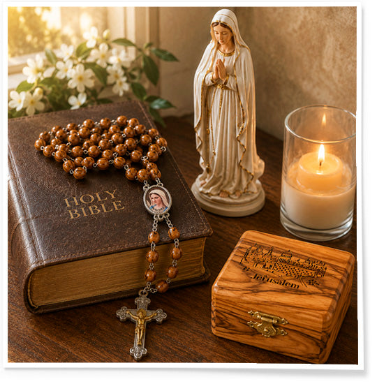 Wooden rosary, wooden box, and statue of a Virgin Mary on a table with a Bible.