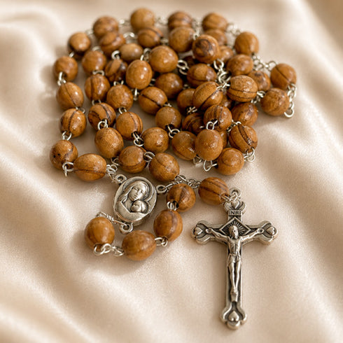 A handmade olive wood rosary with an iron crucifix, featuring a Mary and baby Jesus iron centrepiece.