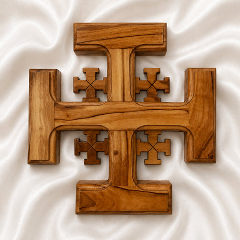 Wooden Jerusalem cross on a white fabric background