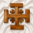Wooden Jerusalem cross on a white fabric background