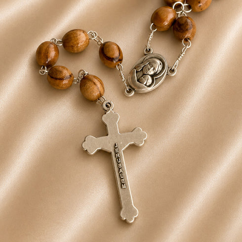 Olive wood praying beads with a silver cross and Jerusalem written on it