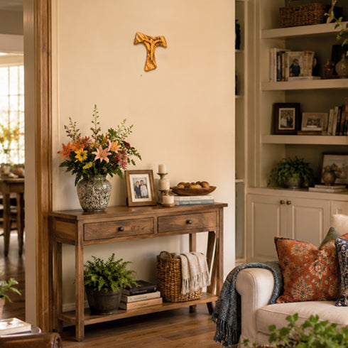 Living room with wooden console table, floral arrangement, and decorative items.