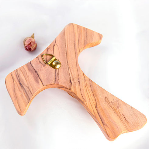 Frontal image of the back of an handmade olive wood tau cross, also known as Saint Anthony's Cross, displayed on a white background with petal.
