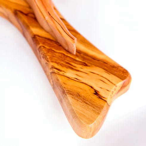 A close up to the bottom of a handmade olive wood tau cross, also known as Saint Anthony's Cross, with modern crucifix design displayed on a white background.