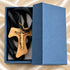 Tau crucifix necklace with olive wood pendant and black braided cord, in blue box