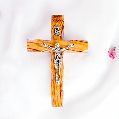 frontal image of a handmade olive wood thorn cross with a crucifix, placed on a white background