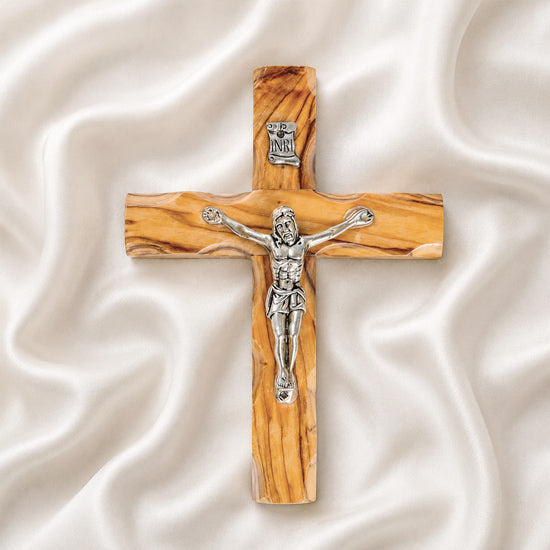 frontal image of a handmade olive wood thorn cross with a crucifix, placed on a white background