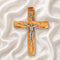 frontal image of a handmade olive wood thorn cross with a crucifix, placed on a white background