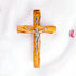 frontal image of a handmade olive wood thorn cross with a crucifix, placed on a white background