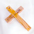 Image showing the back of an handcrafted olive wood thorn cross with a crucifix, placed on a white surface.