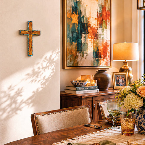 Dining room with wooden table, chairs, and decorative items including a cross and abstract painting.