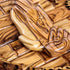 Detailed image of an olive wood decorative plate with Praying Hands engraved.