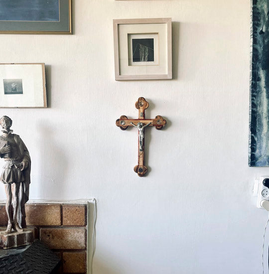 Large handcrafted budded olive wood cross with Four Elements and crucifix hanging on the wall.