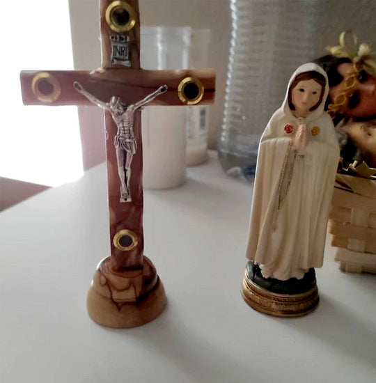 Olive Wood Thorn Cross with Four Holy Elements standing next to a Virgin Mary statue.