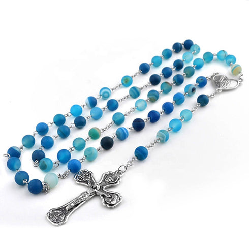 Blue beaded rosary with a silver cross on a white background