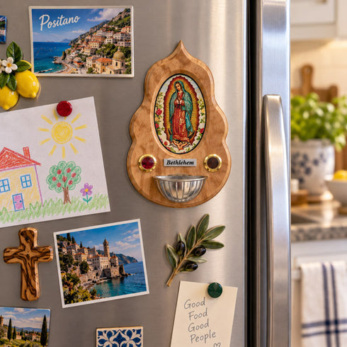 Our Lady of Guadalupe olive wood holy water font displayed on a freezer in a bright kitchen setting