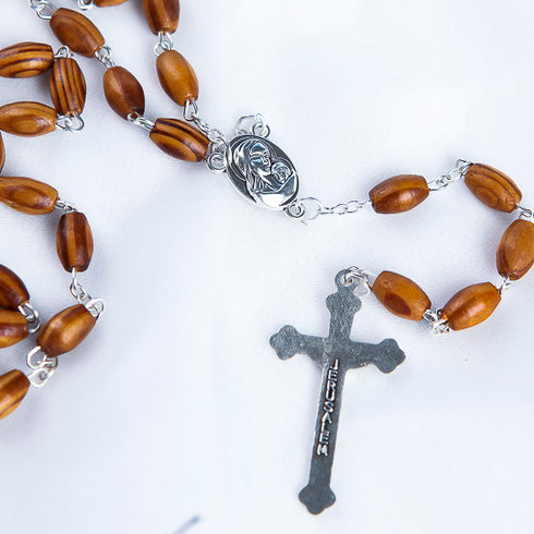 Oval bead olive wood rosary with Mary and Jesus centre piece and a silver cross with Jerusalem written on it