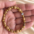 Oval Olive Wood Christian Bracelet with Gold Beads
