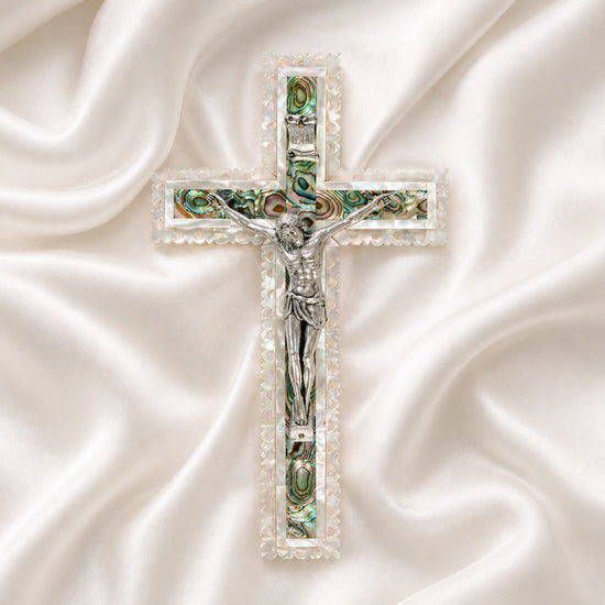 Frontal image of a classic olive wood Latin cross featuring silver crucifix and Mother of Pearl inlay detail on soft white surface.