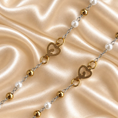 White pearl rosary arranged to show the gold-tone chain, centerpiece and crucifix