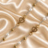 White pearl rosary arranged to show the gold-tone chain, centerpiece and crucifix