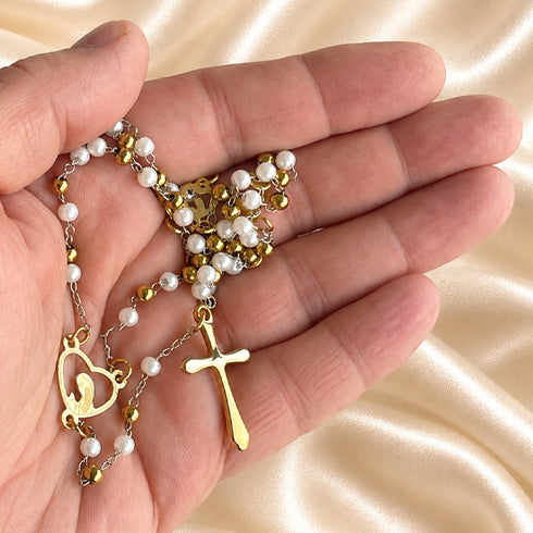 White pearl Catholic rosary with gold-tone chain and crucifix shown from an alternate angle