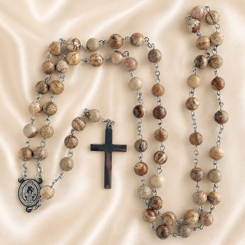 St. Benedict rosary with jasper beads, round medal, and silver-tone cross charms laid out