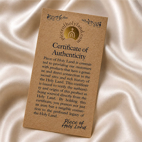 Piece of Holy Land certificate of authenticity on a pink cloth