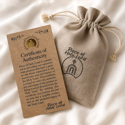 Piece of Holy Land certificate of authenticity with cotton pouch.