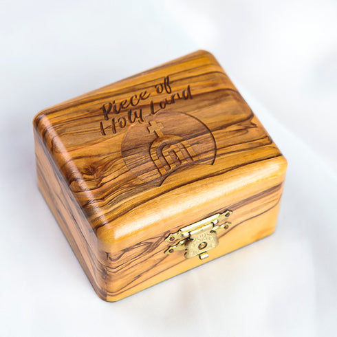 Arial shot of a closed, medium size, olive wood box with Piece of Holy Land logo engraved on it.
