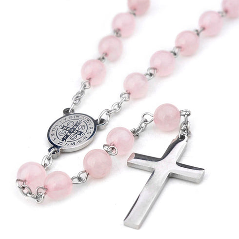 Pink St.Benedict rosary with a silver cross on a white background