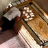 A person praying and placing a prayer notes on the Stone of Anointing inside the Church of the Holy Sepulchre.