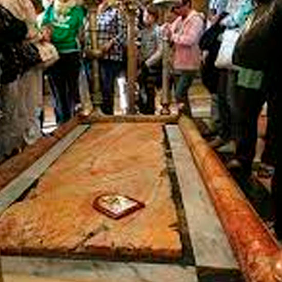 Prayer intention resting on the Stone of Anointing within the Church of the Holy Sepulchre.