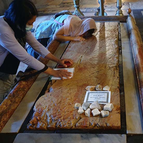 Note of prayer laid on the Stone of Anointing by pilgrims in the Church of the Holy Sepulchre.