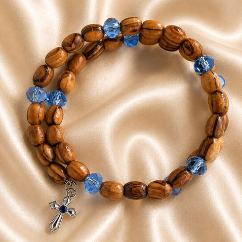 Olive wood beaded wrap bracelet with blue crystal accents and cross pendant charms