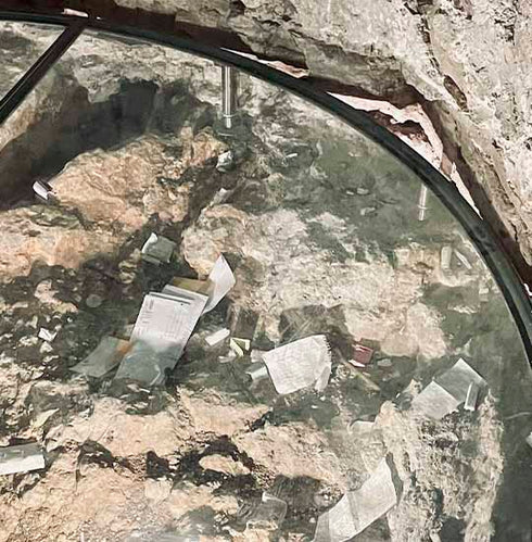 Close-up of prayer notes placed in the Chapel of Adam on the Rock of Calvary inside the Church of the Holy Sepulchre.