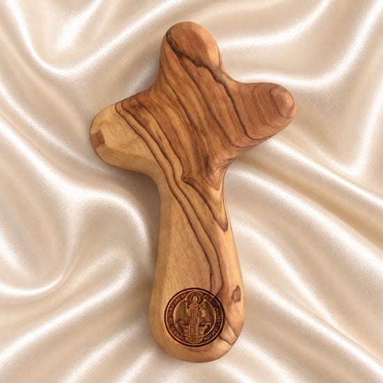 Saint Benedict olive wood comfort cross from Bethlehem with natural wood grain and carved medal design