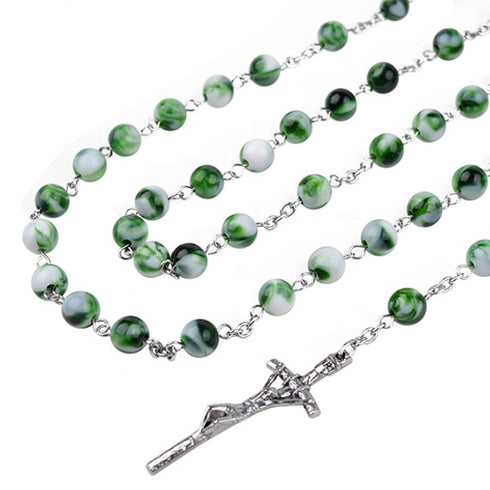 Green and white rosary with a silver cross on a white background