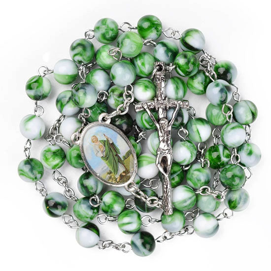 Green and white marbled rosary with silver crucifix on a white background