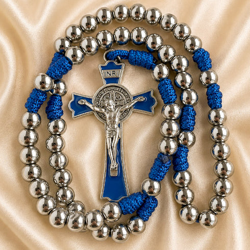 A rosary with silver-tone metal beads, a blue enamel centerpiece, and a silver-tone crucifix.