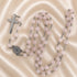 Rosary set with pink jade beads, silver cross, and circular St. Benedict medal