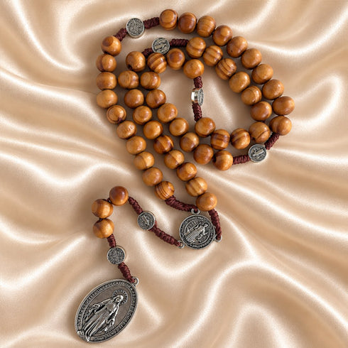 Olive wood rosary with Saint Benedict and Miraculous Medals shown from an alternate angle