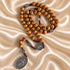 Olive wood rosary with Saint Benedict and Miraculous Medals shown from an alternate angle