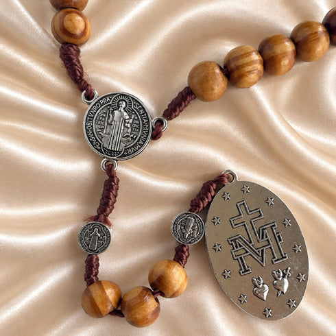 Close view of Saint Benedict and Miraculous Medal olive wood rosary beads and metalwork